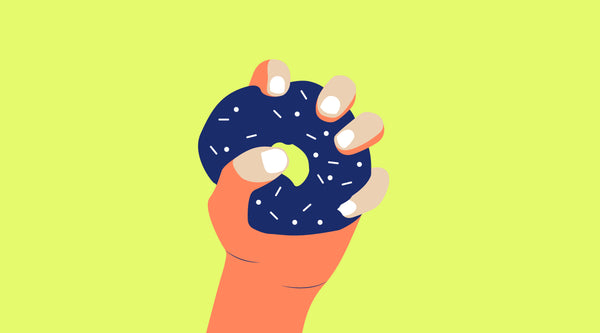 a hand holding a donut 